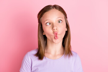 Photo of funky small positive girl make funny face careless good mood isolated on pink color...