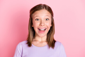 Photo of excited happy small girl reaction discount sale news good mood isolated on pink color...