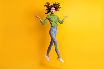 Fototapeta na wymiar Full body photo of lovely sweet cheerful woman jump air fly hair raise hands isolated on yellow color background