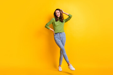 Full body photo of charming attractive young lady look copyspace touch hair hand waist isolated on bright yellow color background