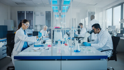 Modern Medical Research Laboratory: Diverse Team of Scientists Working with Pipette, Analysing Biochemicals Samples, Talking. Scientific Lab for Medicine, Microbiology Development. Advanced Equipment