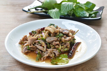Thai spicy chop duck meat salad and fresh basil leaf with eggplant on plate