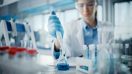 Medical Research Laboratory: Portrait of a Beautiful Female Scientist in Goggles Using Micro...
