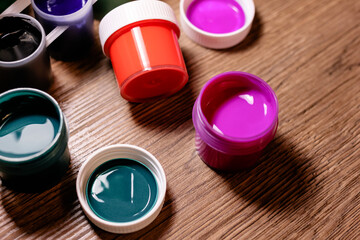 Jars of gouache paint. Creativity, education, art, drawing, painting concept, background. Selective...