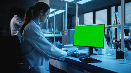 Modern Medical Research Laboratory: Portrait of Female Scientist working on Computer Showing Green Chroma Key Screen. Advanced Scientific Lab, Medicine Development Facility Biotechnology