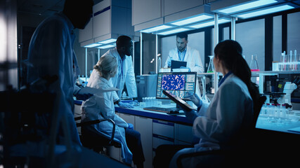 Medical Research Laboratory Meeting: Diverse Team of Scientists Use Digital Tablet Computer, Discuss Innovative Biotechnology. Advanced Lab for Medicine, Technology Development. Blue Evening Shot