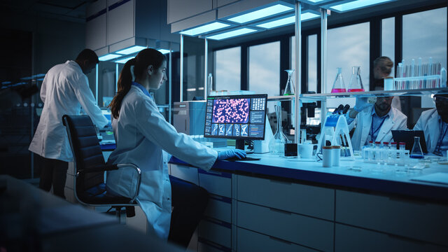Modern Medical Research Laboratory: Portrait of Female Scientist Working on Computer, Analysing Biochemicals. Advanced Scientific Lab for Medicine, Biotechnology Development.