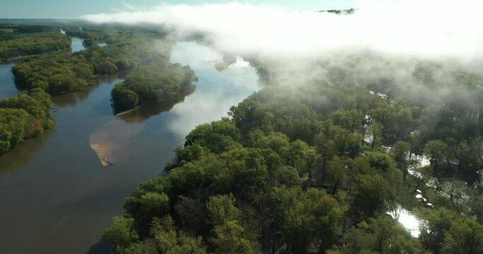 Clouds and a fog bank obscure the hills along the Wisconsin River during an autumn morning near Prairie du Chien in Wisconsin