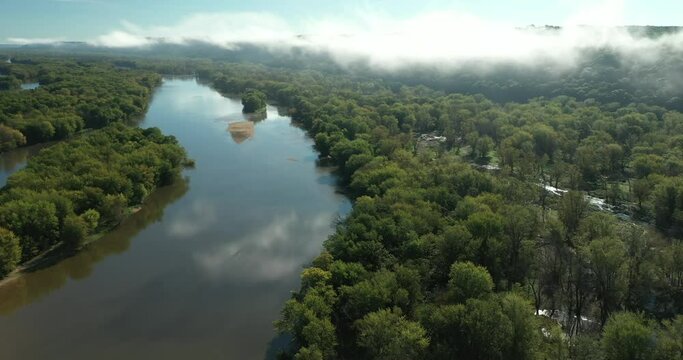 Clouds and a fog bank obscure the hills along the Wisconsin River during an autumn morning near Prairie du Chien in Wisconsin