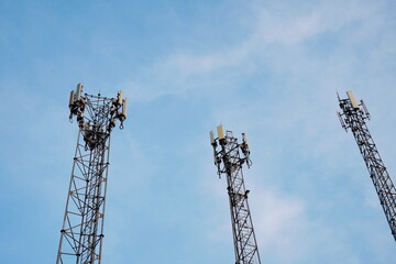 Telecommunication tower of 4G and 5G cellular. Macro Base Station. 5G radio network telecommunication equipment with radio modules and smart antennas mounted on a metal on blue sky background.