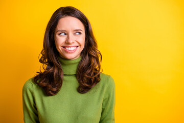 Fototapeta premium Portrait of young beautiful cheerful smiling good mood positive charming woman look copyspace isolated on yellow color background