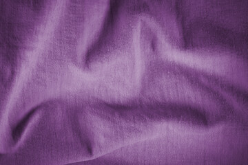 Fototapeta na wymiar Texture of crumpled purple cotton fabric. Purple background for text and design. Texture of violet crumpled italian fabric