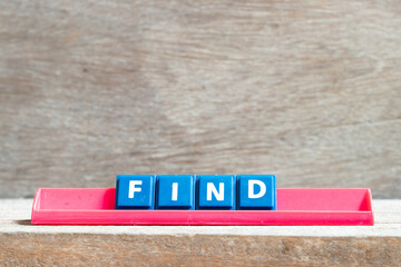 Tile letter on red rack in word find on wood background