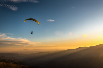 paraglider flies over the mountains