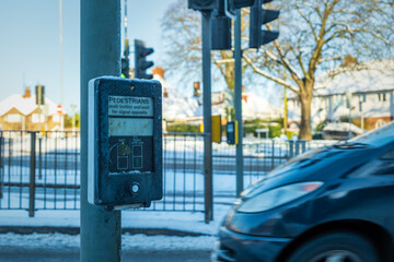 Fototapeta premium Pedestrian control road crossing winter snow frozen in england uk