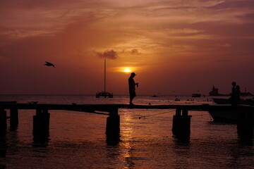 Fototapeta premium silhouette of a person on a pier