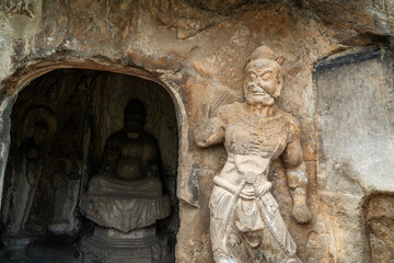 Fototapeta na wymiar Longmen Grottoes with Buddha's figures are Starting with the Northern Wei Dynasty in 493 AD. It is one of the four notable grottoes in China.