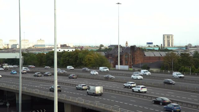 Following vehicles driving highway M8 in Glasgow. Wide following shot
