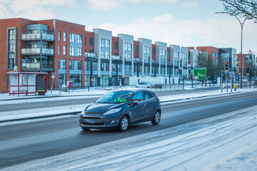 Obraz premium Driving on winter snow road in town in england uk during covid lockdown