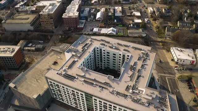 Giant square high building in downtown Raleigh on a sunny day. Drone dolly shot