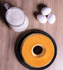 Obraz na płótnie Canvas milk pudding with eggs on wooden background