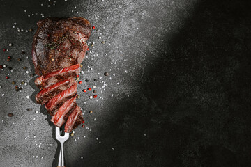 grilled beef steak on a dark background. expensive marbled beef of the highest grade fried to rare...
