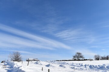 A farm in winter under a blue sky, Québec