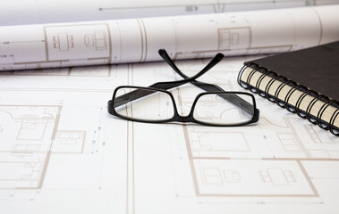 Residential building drawings and pencils on an office desk. Construction concept.