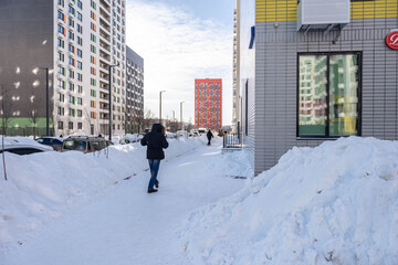 Moscow. Russia. February 2021. Cleared the snow from the paths after a huge snowfall. Deep walking paths in Moscow.