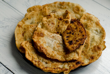 Fried flatbread with meat filling. Known in Asia as chebureks.