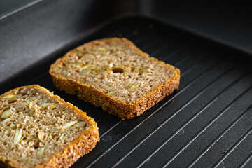 A grain bread on a grill pan. Homecooking during the quarantine time. 