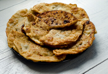 Fried flatbread with meat filling. Known in Asia as chebureks.