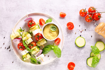 vegetable skewer with courgette,  cherry tomato, onion and cheese feta with dipping sauce