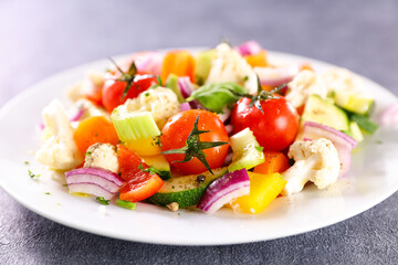 grilled vegetables and herbs in plate