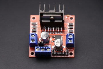 Motor driver used in interface between motor and control circuits used to make electronic projects. Driver for stepper motor on black background