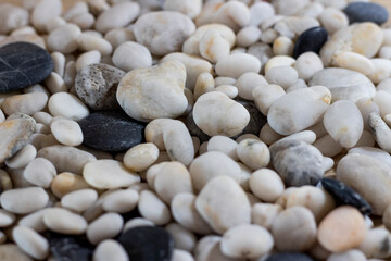Background of sea pebbles close-up. Sea pebble texture