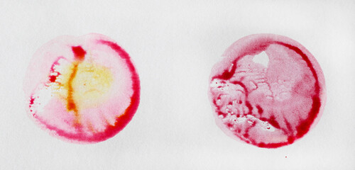 two water colour circles in red and pink colour on white paper background