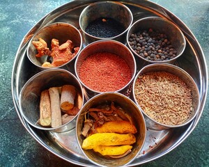 Various dry spices and Raw herbs in small bowls(Anjaraipetti).Indian traditional things.