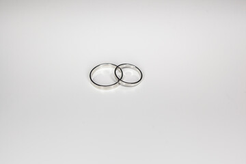 classic wedding rings made of white metal on a white background