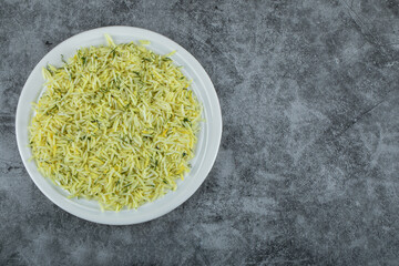 Plate of delicious rice on marble background