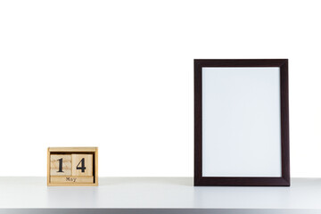 Wooden calendar 14 may with frame for photo on white table and background