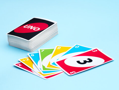 Ukraine, Cherkassy, February 24 2021: Uno game deck and cards fan on blue background