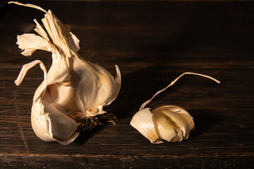 Garlic on the dark wooden table.