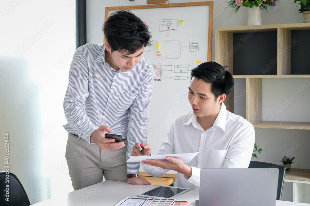 Poster asian man designers are looking for ideas to make a website ui ux mobile phone application at the of