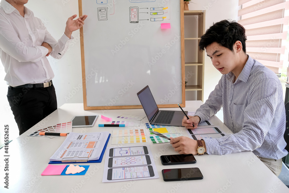 Poster asian man designers are looking for ideas to make a website ui ux mobile phone application at the of