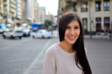 Fototapeta premium Pretty Woman with radiant smile in the city