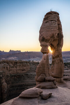 Delicate Arch at sunset with sunburst, Arches National Park, Utah, United States of America, North America