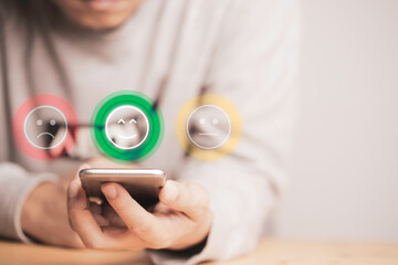Customer using smartphone with face icons and info graphic percentage to evaluate product after use...