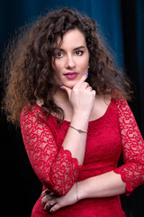 Vertical portrait of a beautiful brunette girl with curly hair.
