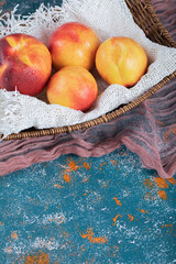 Yellow red peaches isolated on a piece of white burlap